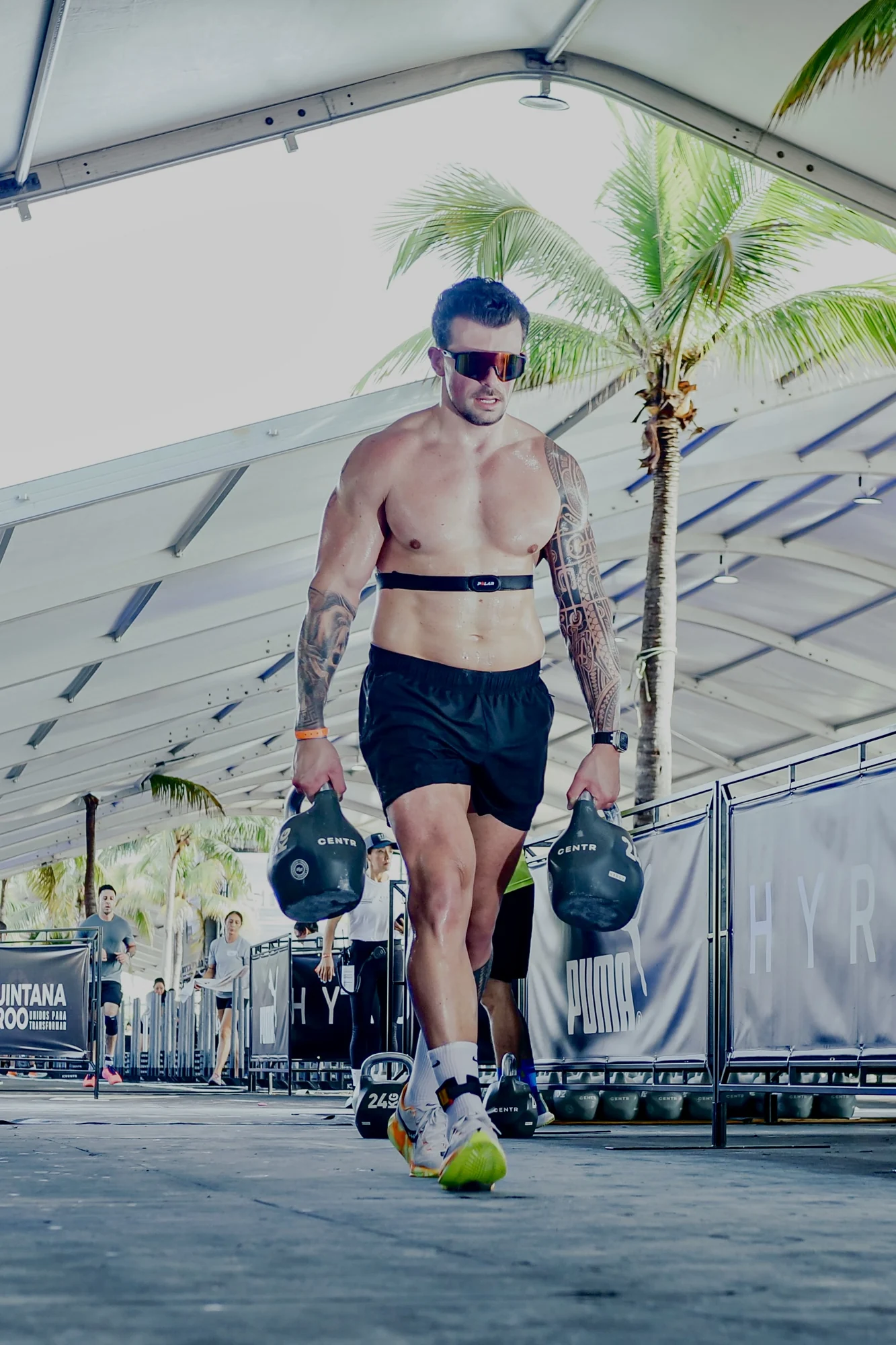Romain competing in the farmers carry at HYROX